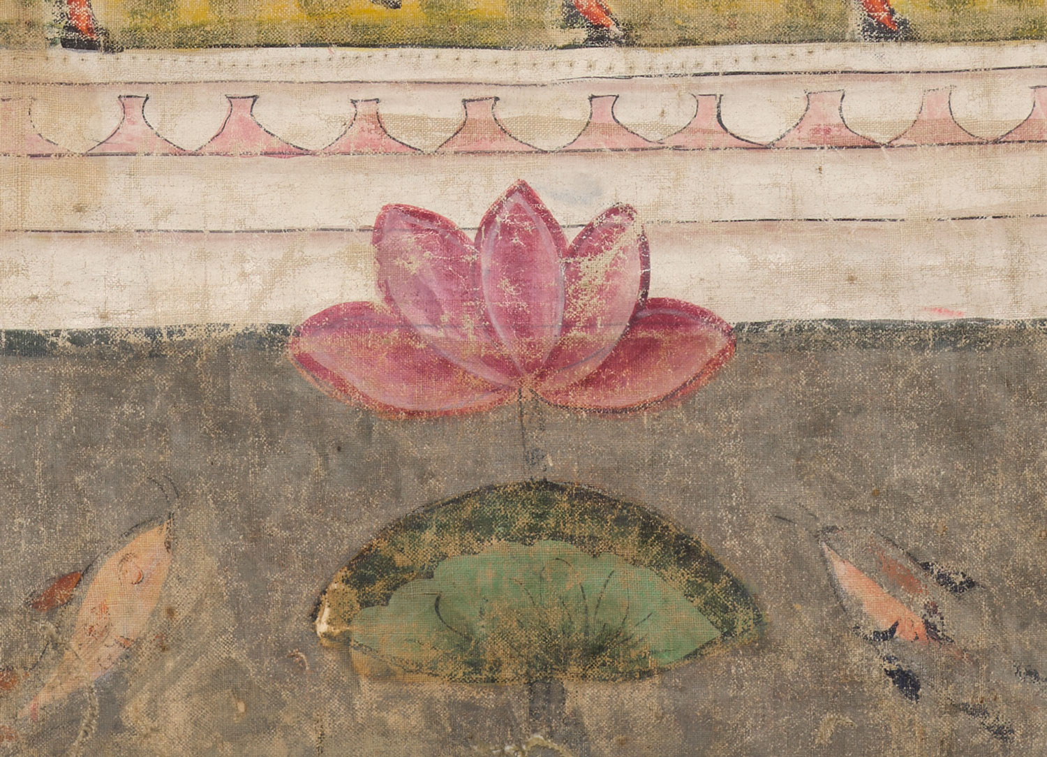 A pink lotus flower rises from a green leaf-pad in silvery-gray water. On either side of the lotus, fish look upward.