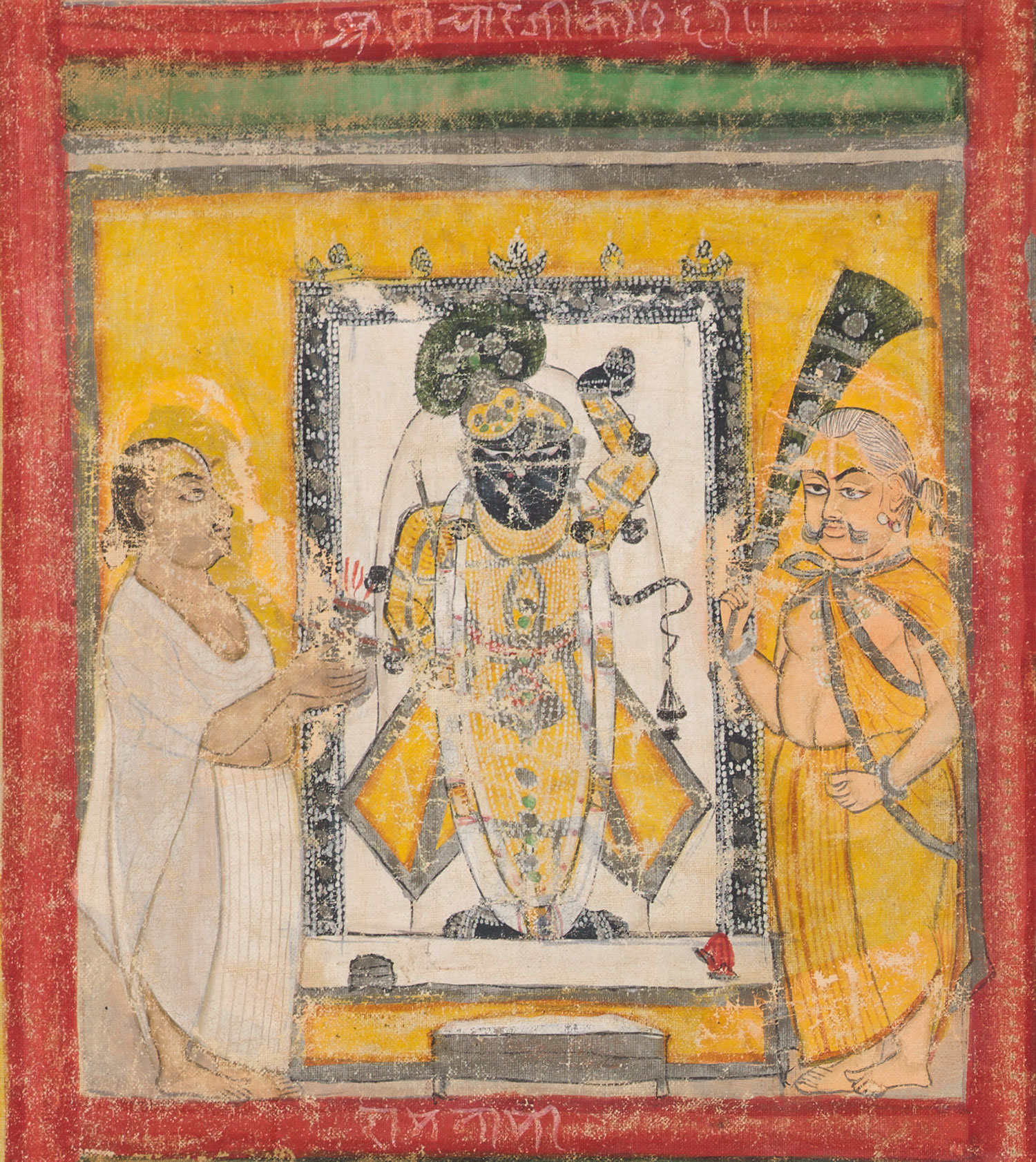 Two men stand to either side of a man with blue-black skin and an upraised arm. A red frame surrounds the image, with an inscription in Hindi on the top edge.