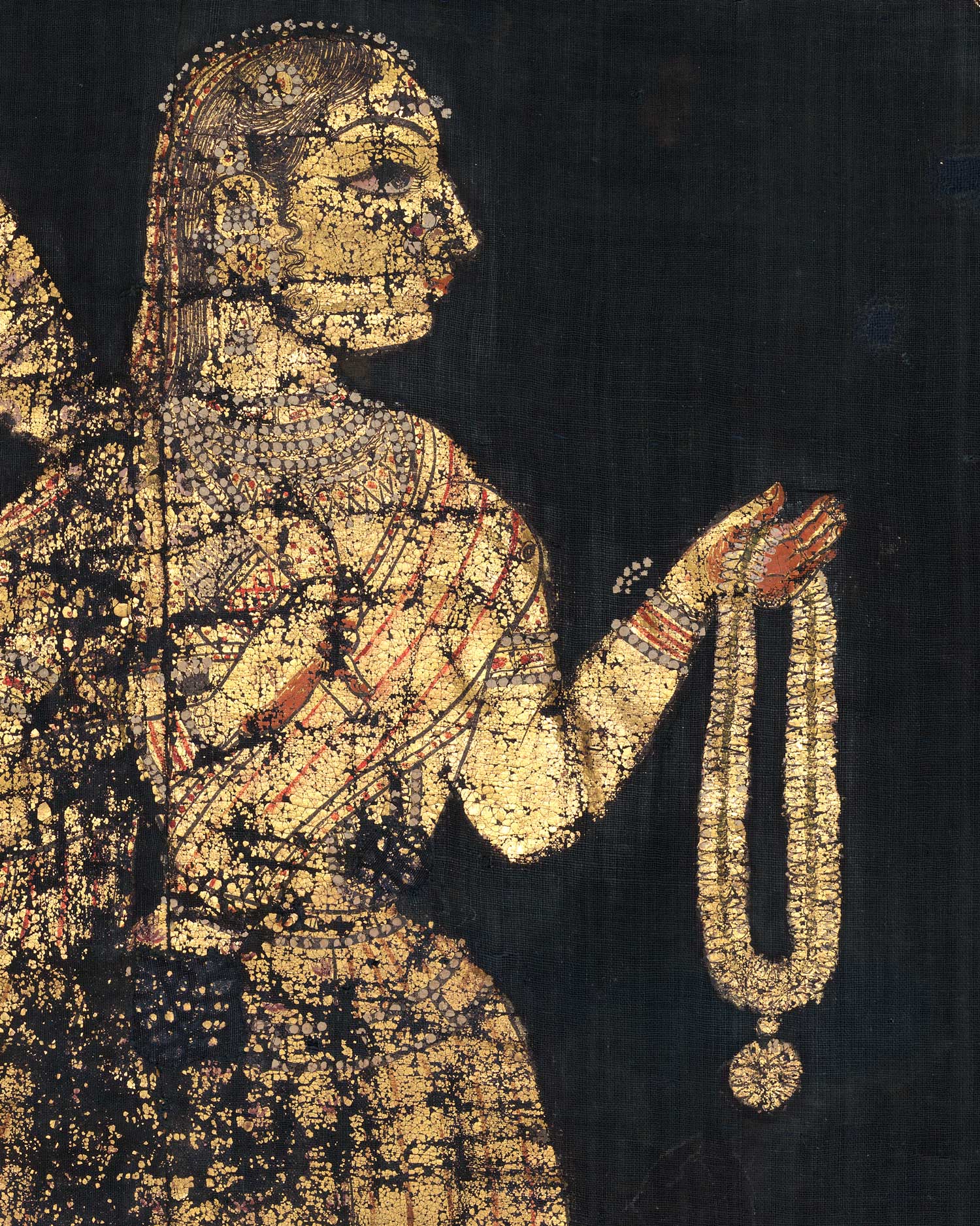 Against a blue-black background, a woman is rendered in gold paint with black, white, and red details. She holds a garland and a fan.