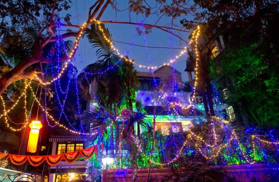 String lights and decorations hung outside of a multi-story building.