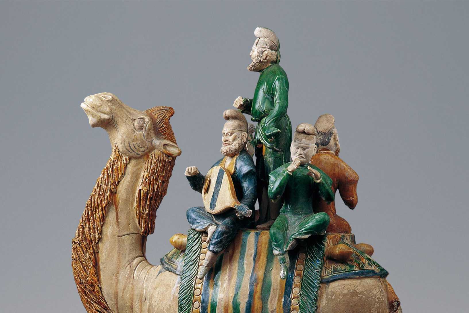 Sculpture depicting three figures riding a camel.