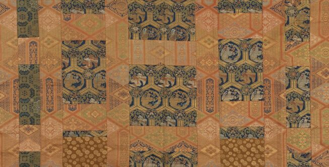 A patchwork silk textile in tones of brown, gold, and blue, composed of intricate geometric patterns.