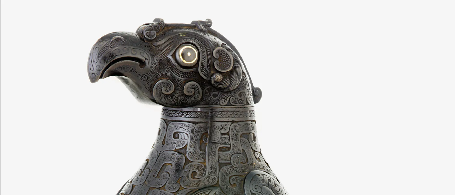 A close-up image of a bird made of what appears to be some sort of metal with intricate twisting patterns along its face and neck.