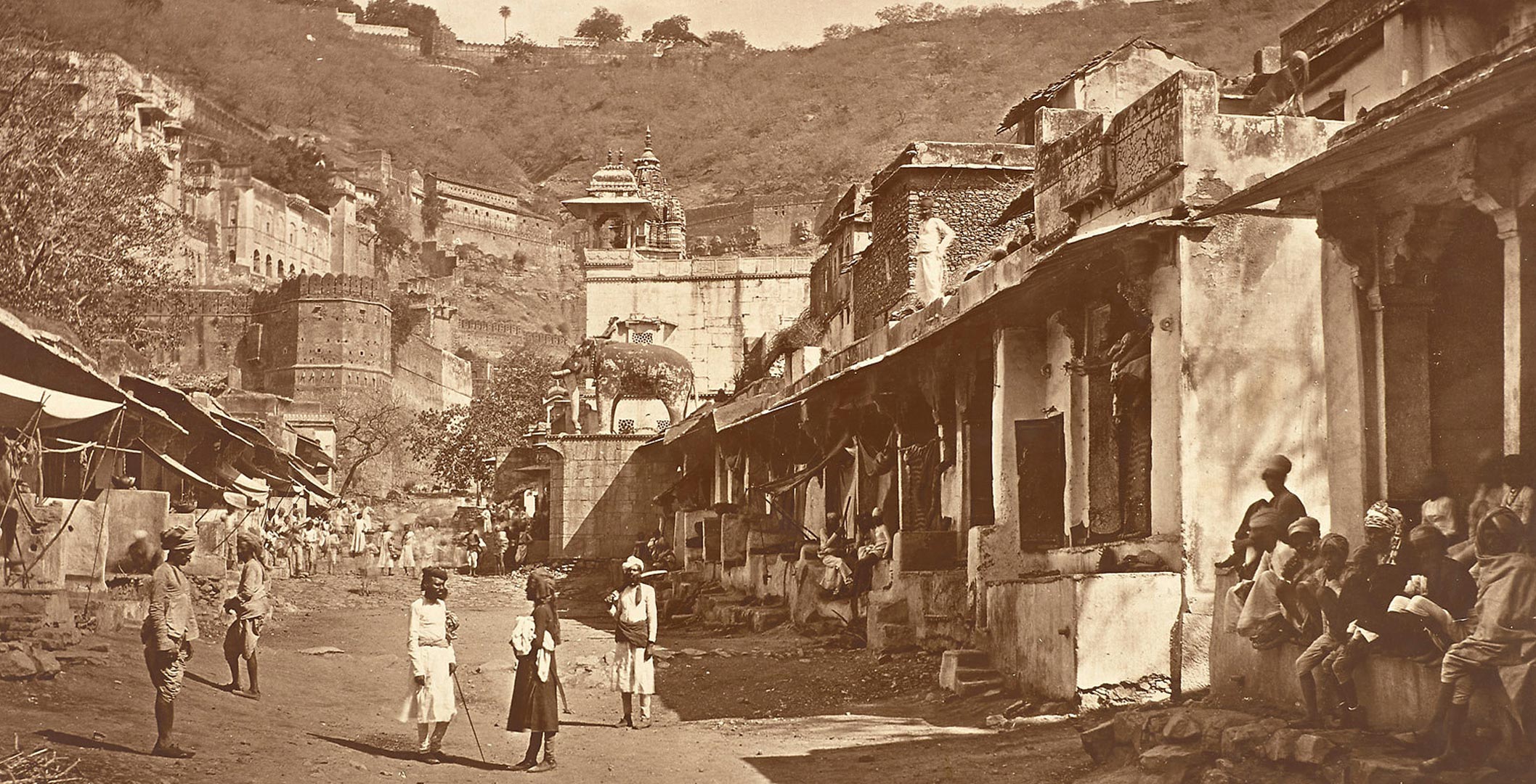 detail from an archival photo showing several figures walking in the street