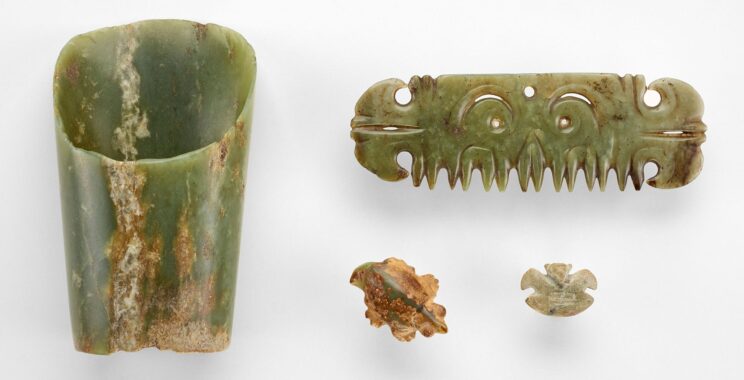 Four jade objects arranged against a white background.