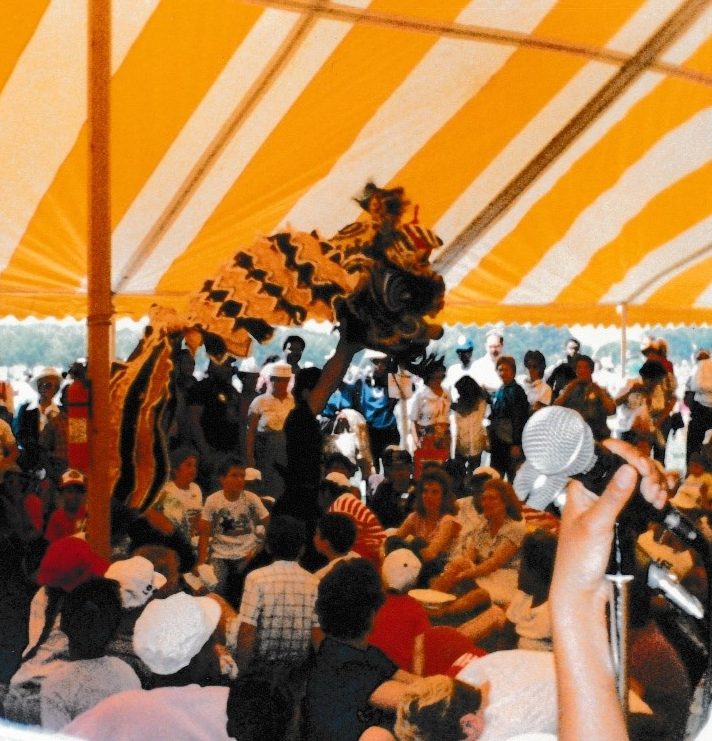 Lion dance being performed in a crowded tent