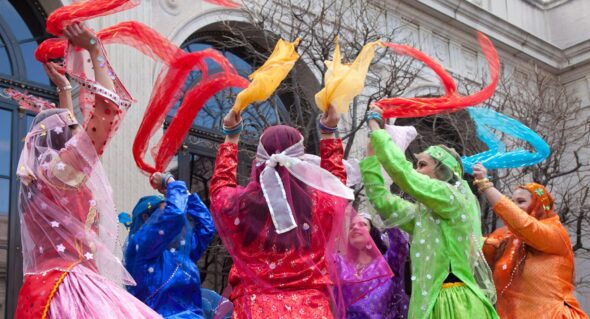 Dancers wave colored scarves at a NMAA Nowruz celebration.