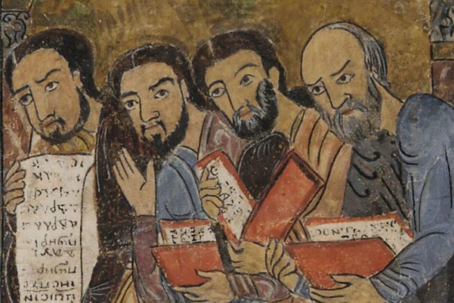 four men holding books or scrolls in hand