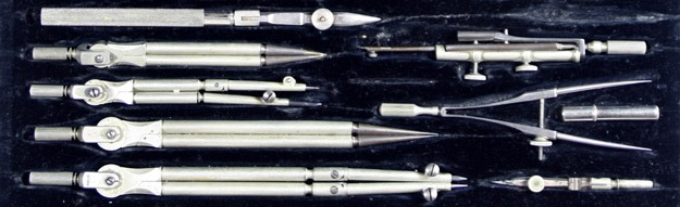 several tools laid out on a dark background, possibly in a case or on a dark cloth.