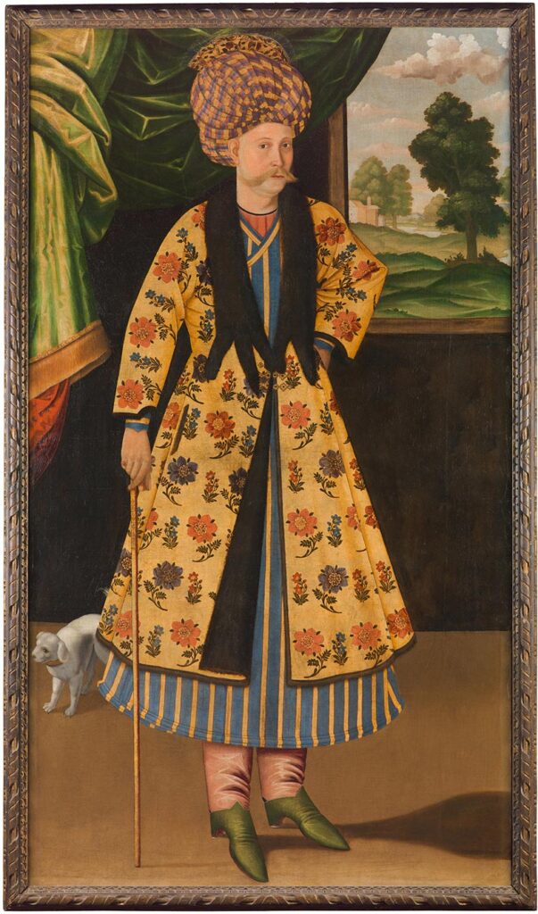 A painted portrait of a man with a large mustache and a cane, wearing a turban and an opulent floral coat. He stands in a room with a draped green curtain and an open window behind him, and is accompanied by a small dog.