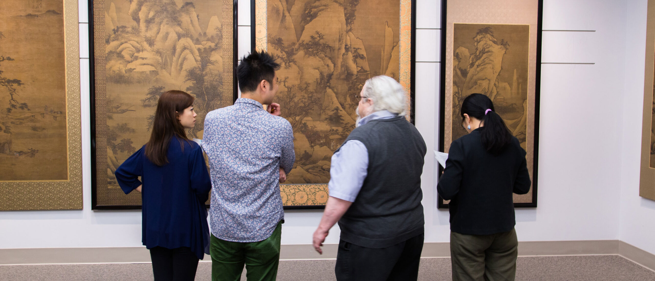 Interns view Chinese landscape paintings with associate curator for Chinese Painting and Calligraphy, Stephen Allee.