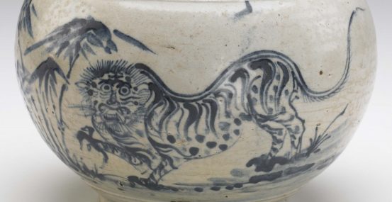 Ceramic jar depicting an animal figure on the side.