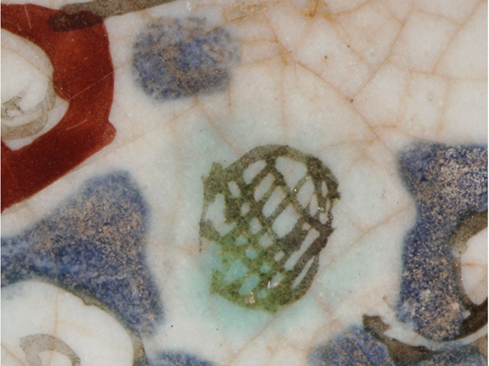 detail of a black line that changed color on turquoise glaze on the reverse of the Siege Scene Plate.