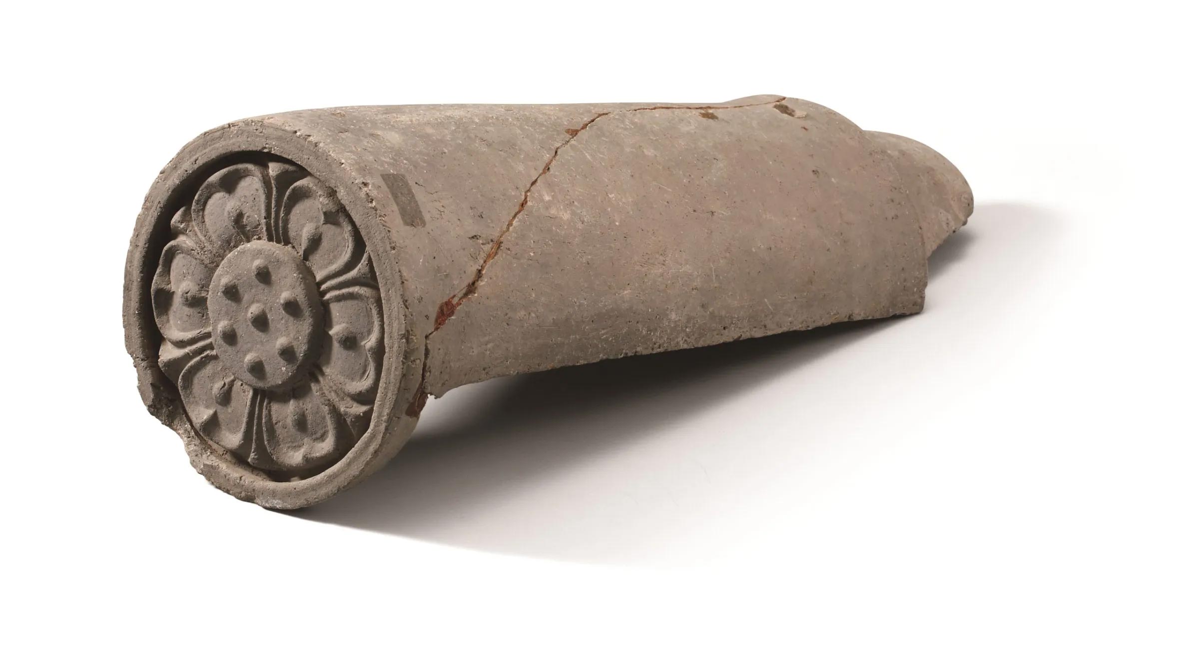 cylindrical object with flower design on the circular end