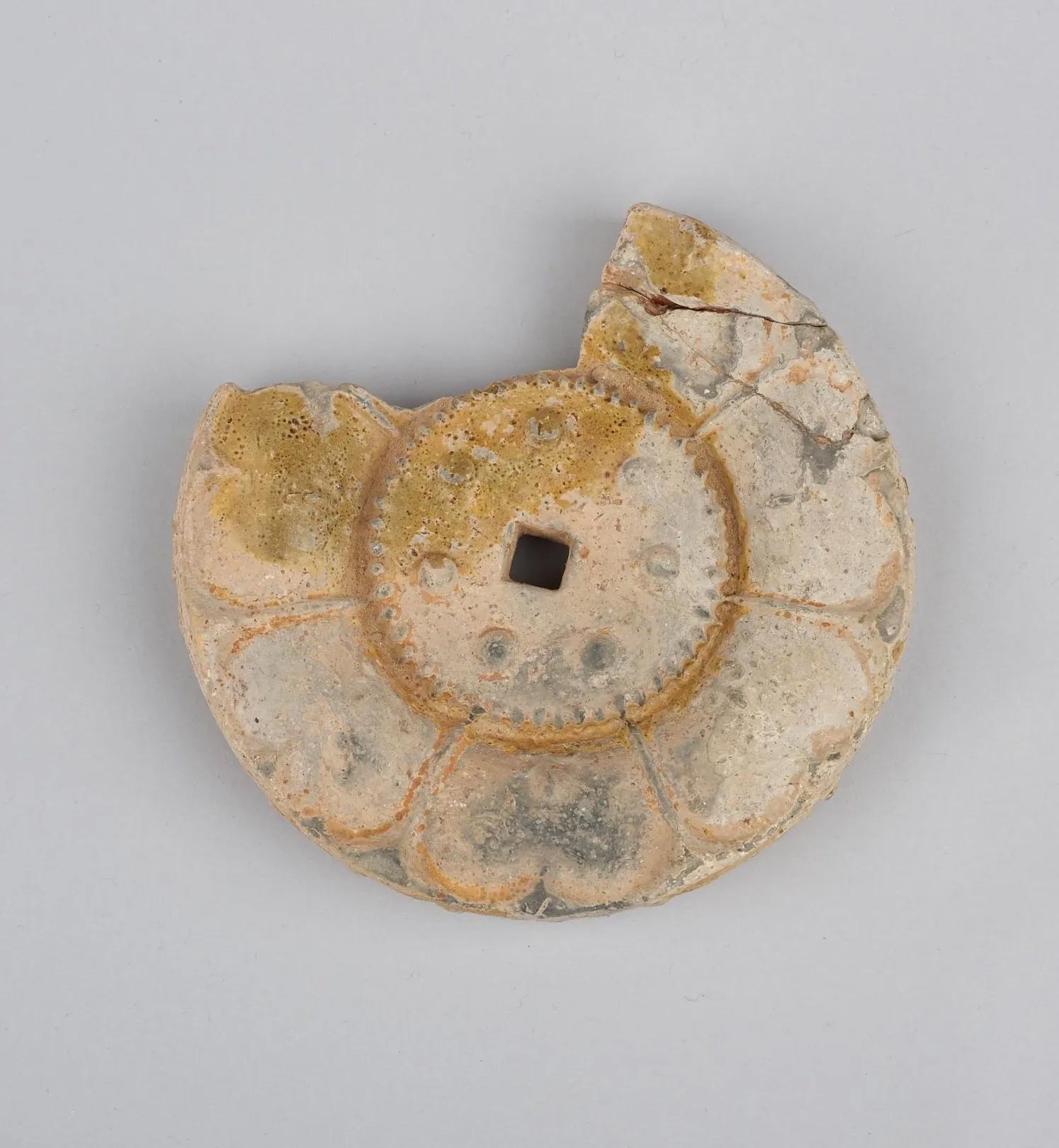 broken circular flower-shaped tile