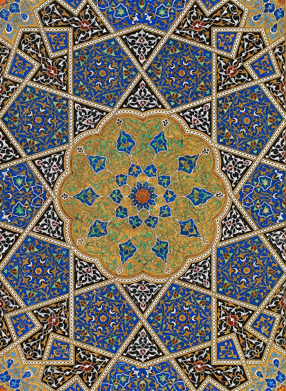 Book cover of The Art of the Quran, featuring a strong geometric pattern in shades of blue, gold, and black.