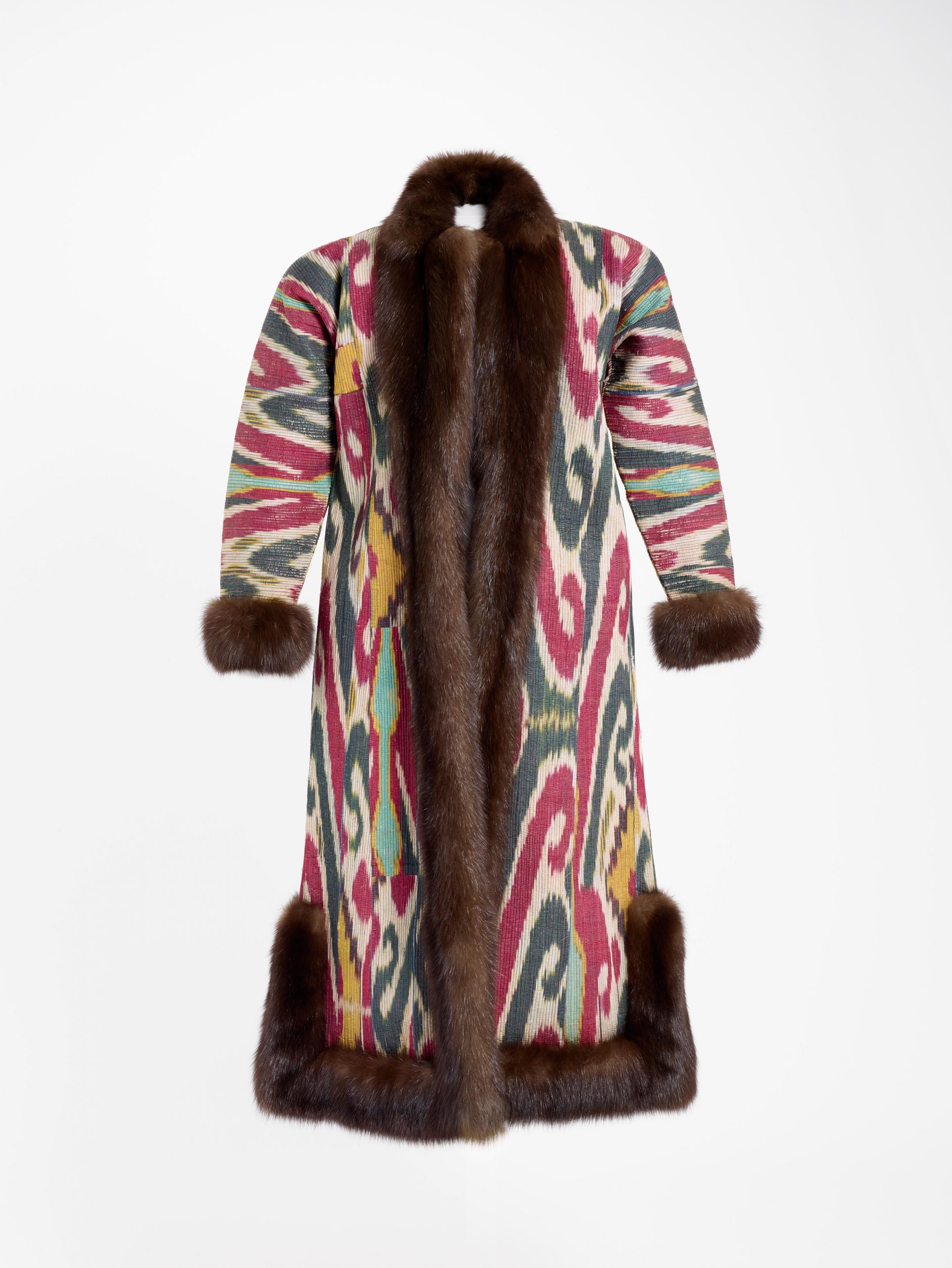 Multicolored long coat with brown fur trim.