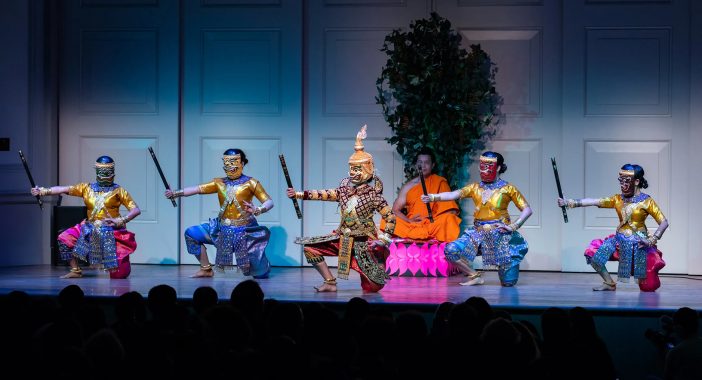 Dancers portray Mara and his demon army, while another actor portraying the historical Buddha meditates behind them on stage