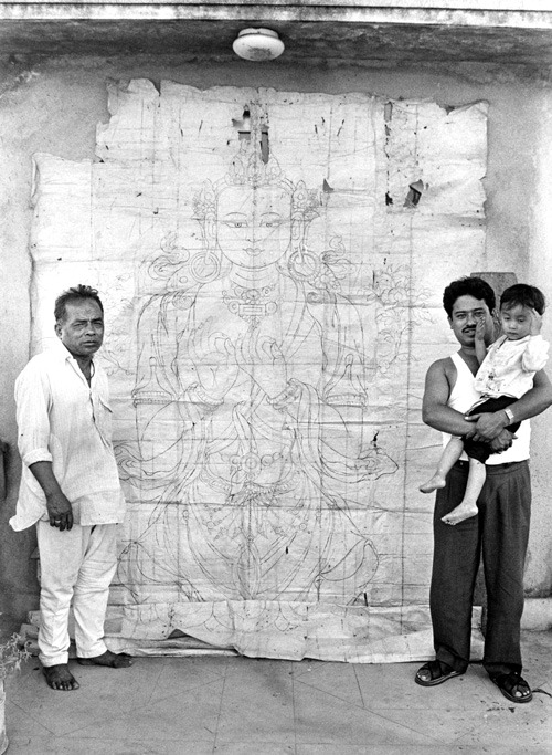 two men stand in front of the drawing