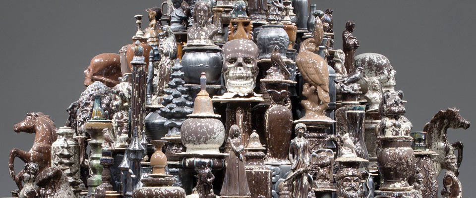 A mountain of brown and black glazed manufactured ceramic objects