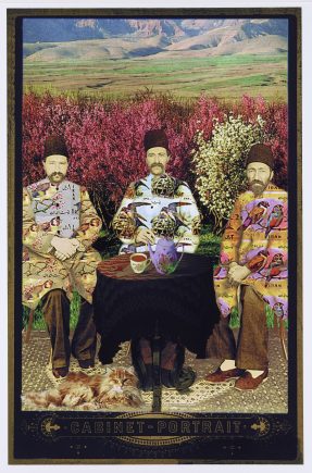 Colorized photo of three men seated outdoors, with mountains and fields in the background