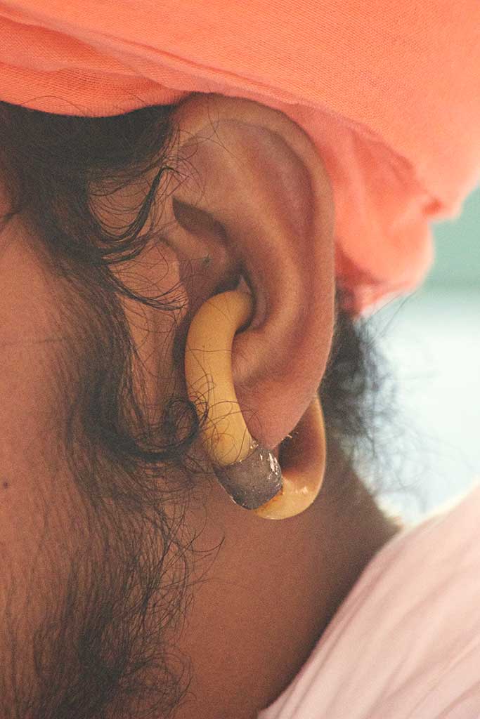 a pierced ear with a antelope horn earring