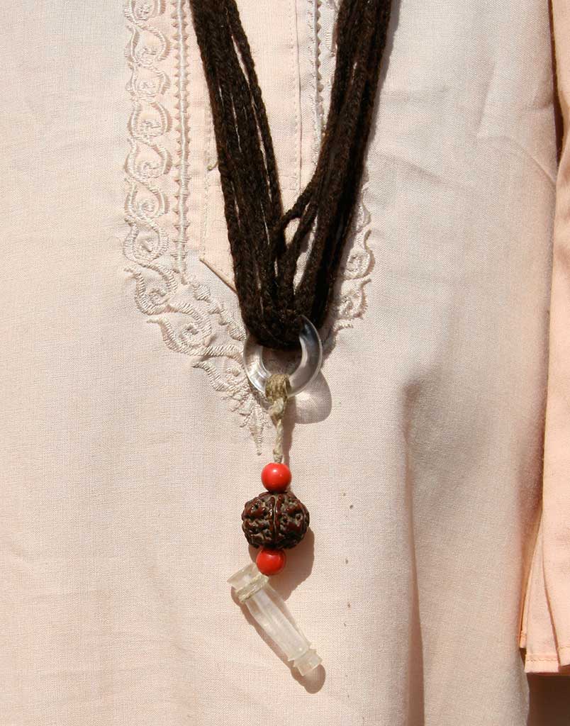 a necklace made of spun black wool with beads hanging from it