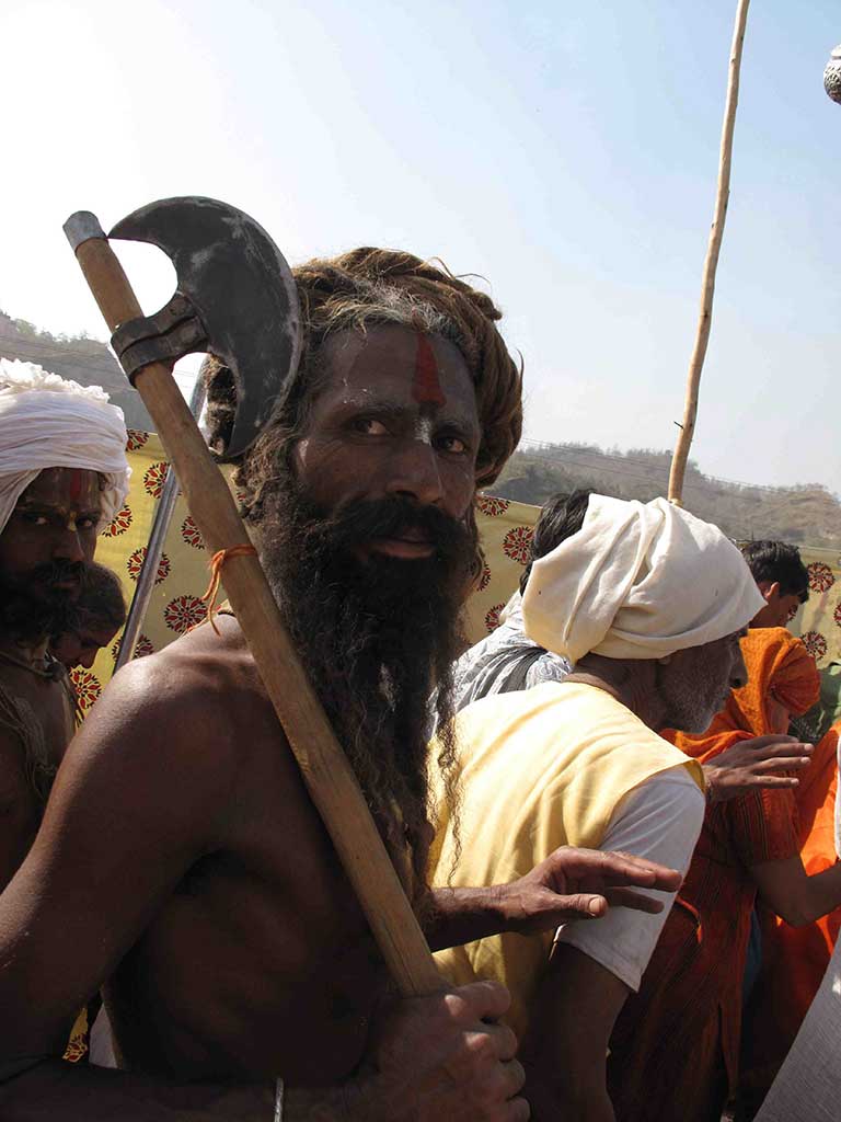 a man with a long beard and markings on his forehead carrying an axe