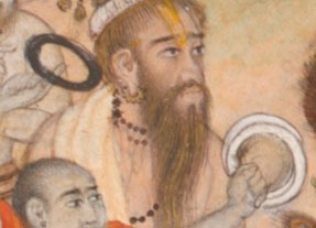 a man with long beard, wearing earrings and a necklace