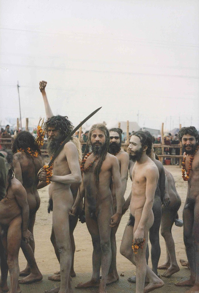 a group of bearded naked men standing, one man holding a sword