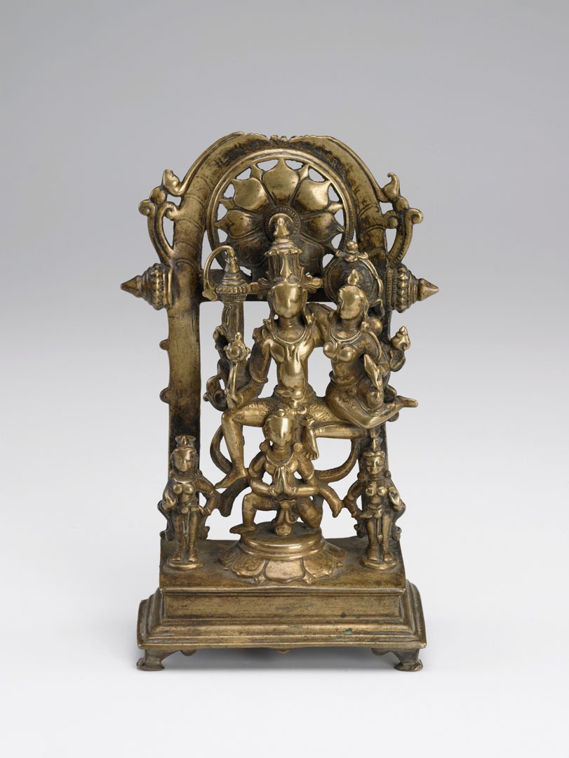 A bronze sculpture including five figures against an ornate backdrop/frame.