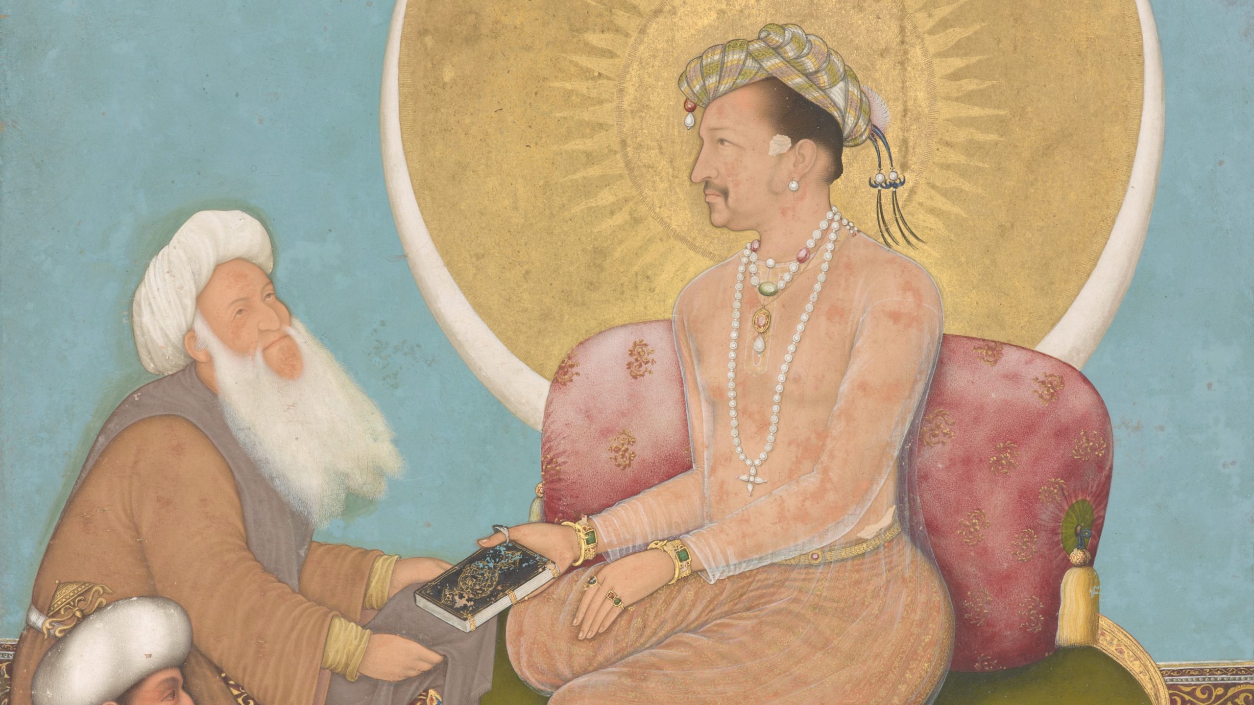 A figure sits cross-legged on a red cushion, an circular golden halo framing his face in profile. The sitting figure offers an ornately designed book to a bearded figure kneeling before him.