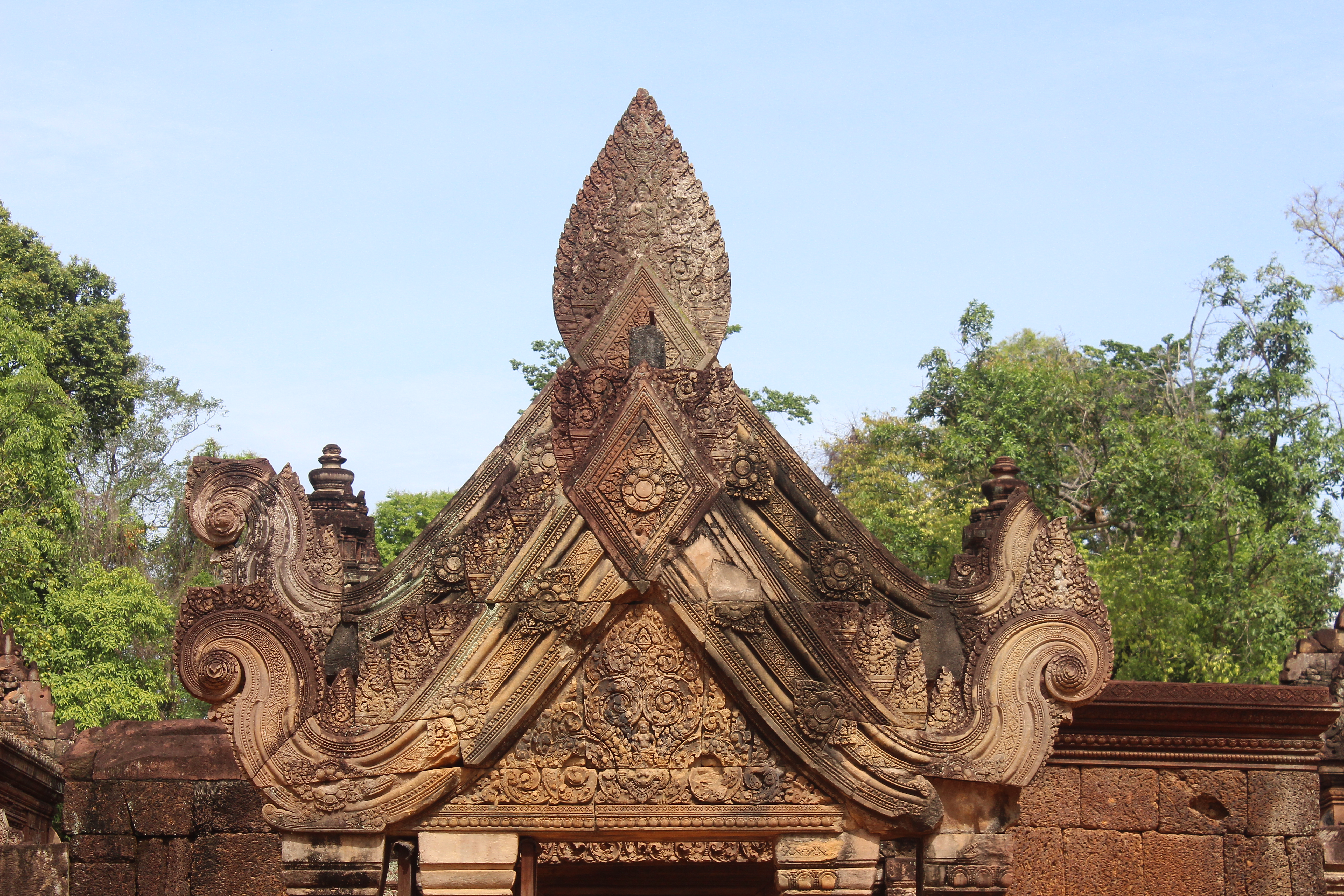 Finely carved sandstone pointed archway terminating in naga finials