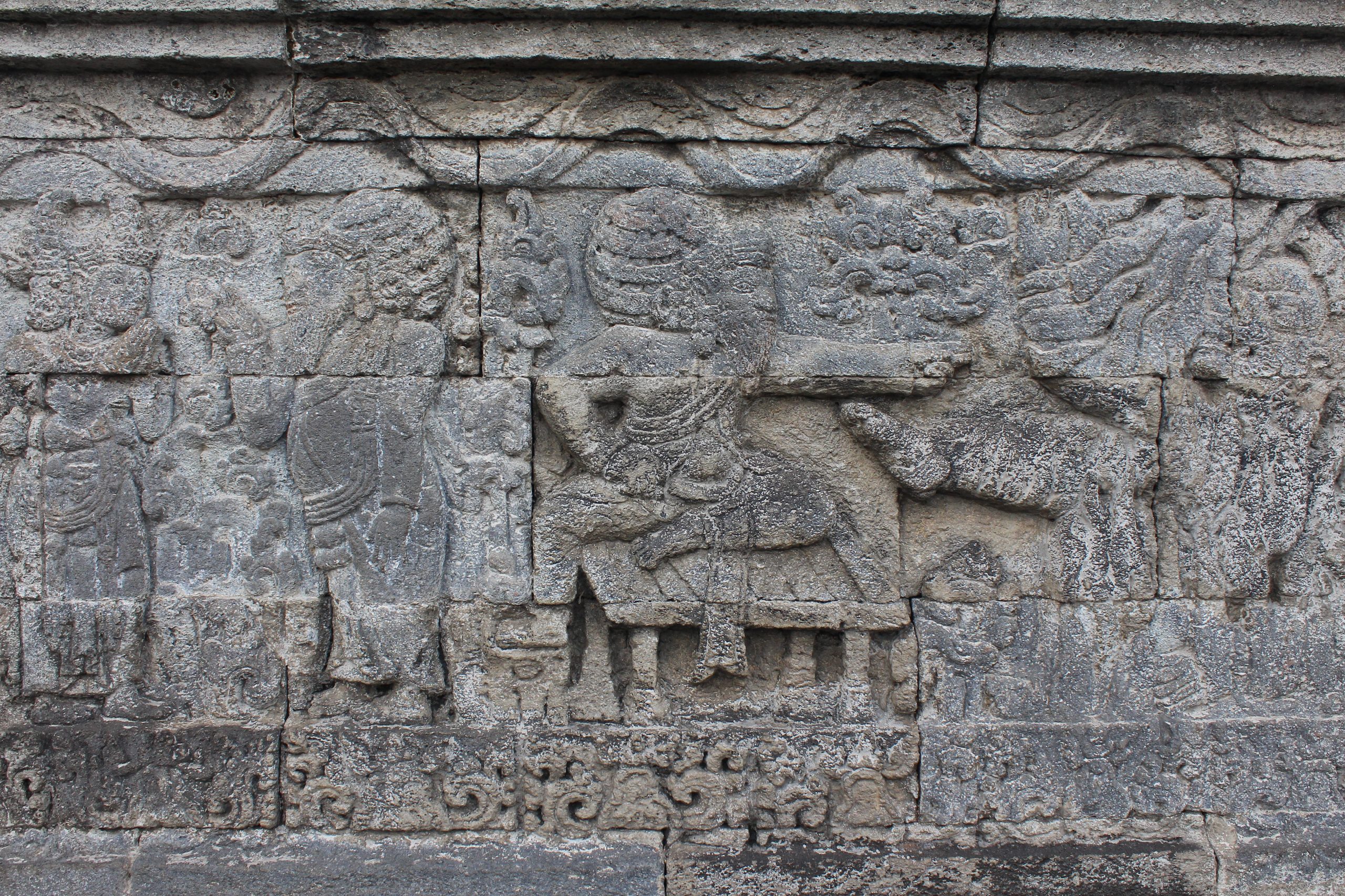 Relief showing a guru seated on a platform