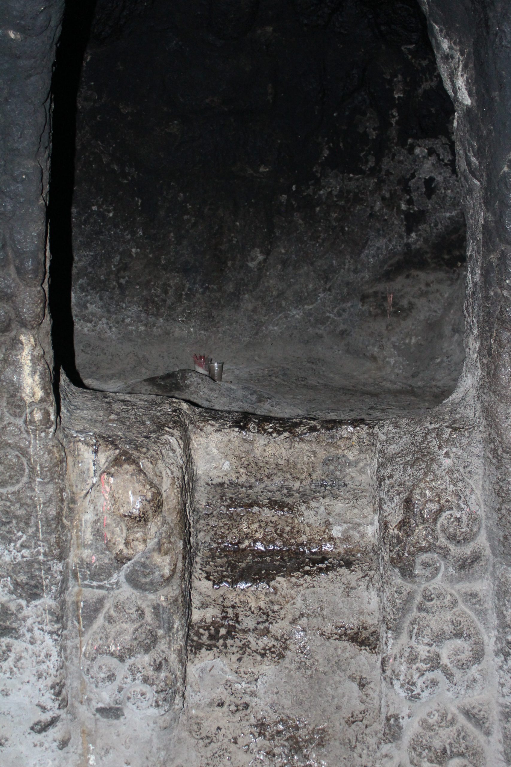 Damaged steps leading up to a small cave