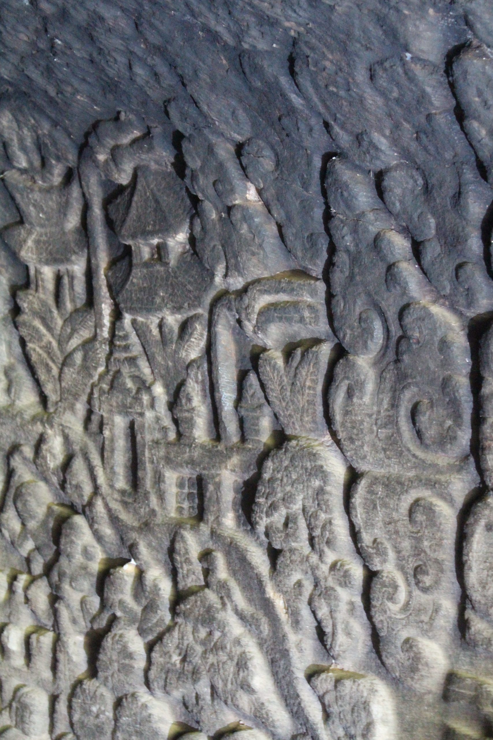 Relief showing houses in a forest