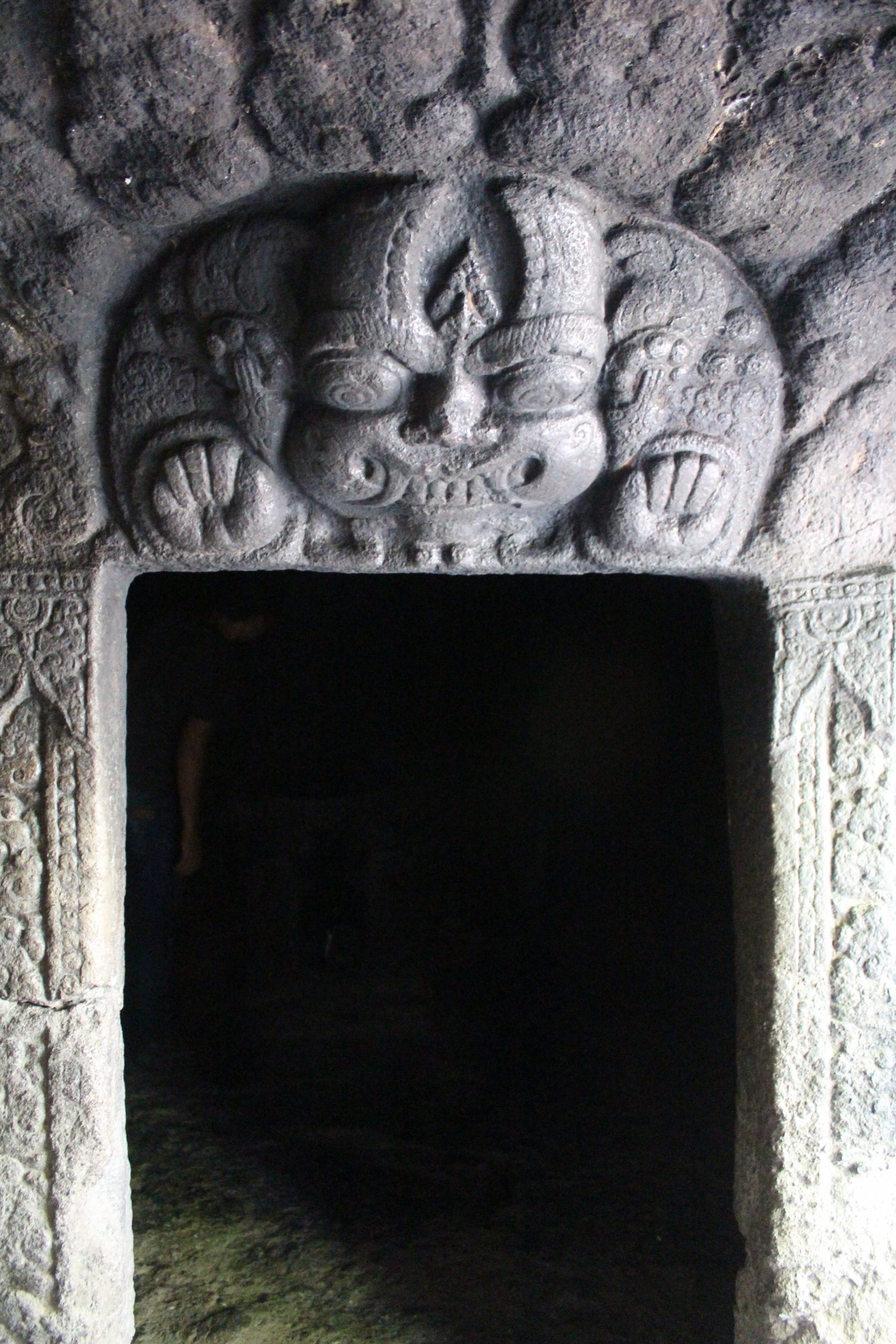 Demon face over a dark doorway