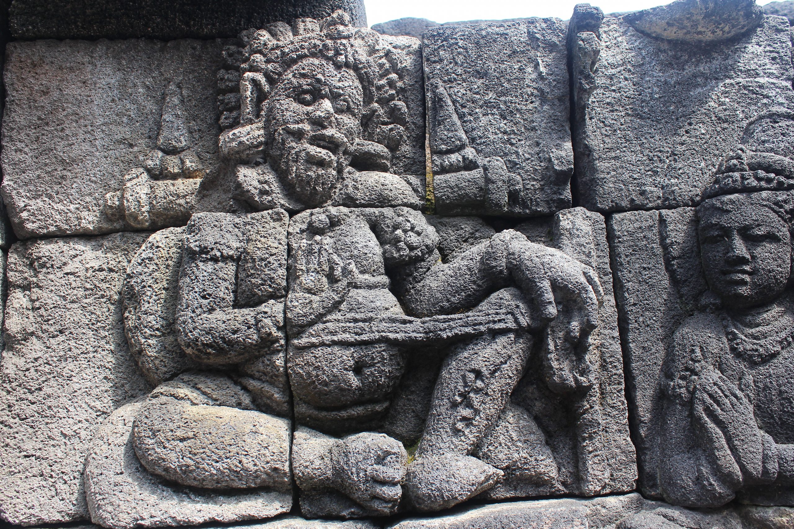 Relief carving showing a corpulent guru with devotee