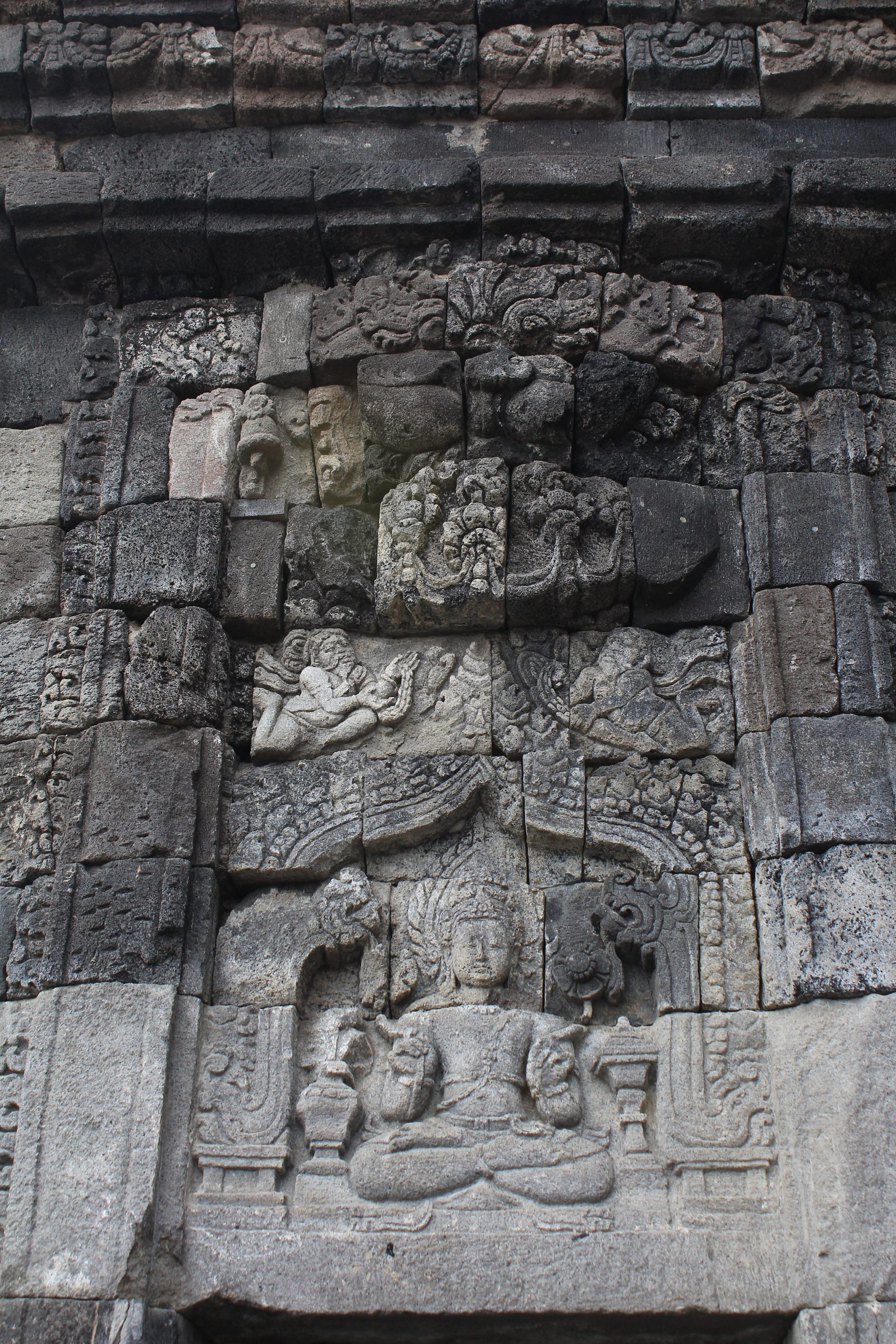 Relief panel showing buddhist figure in lotus posture with flying rishis above