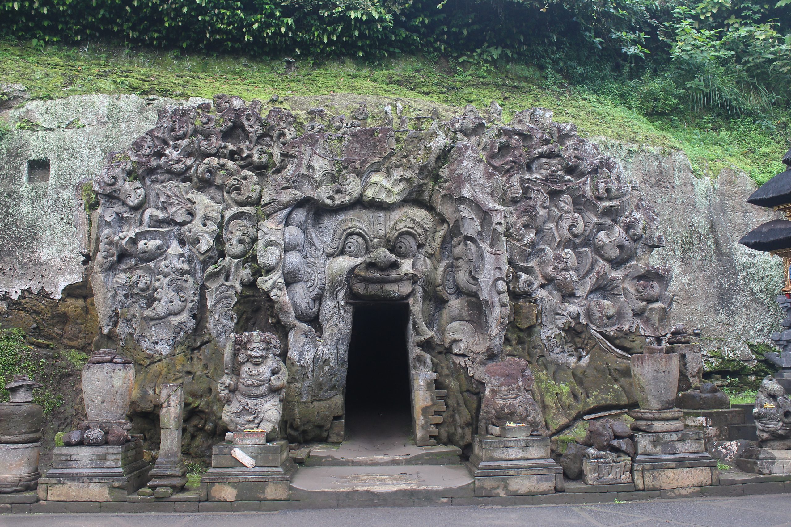 Cave façade with demonic face over door