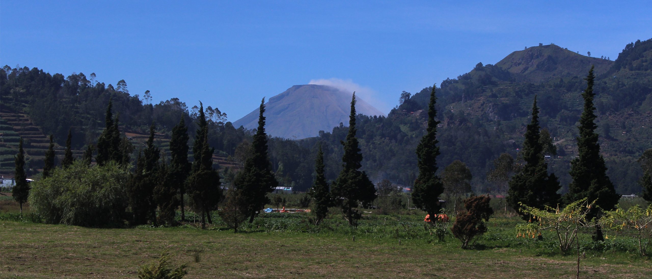 Volcano top with green hills to both sides