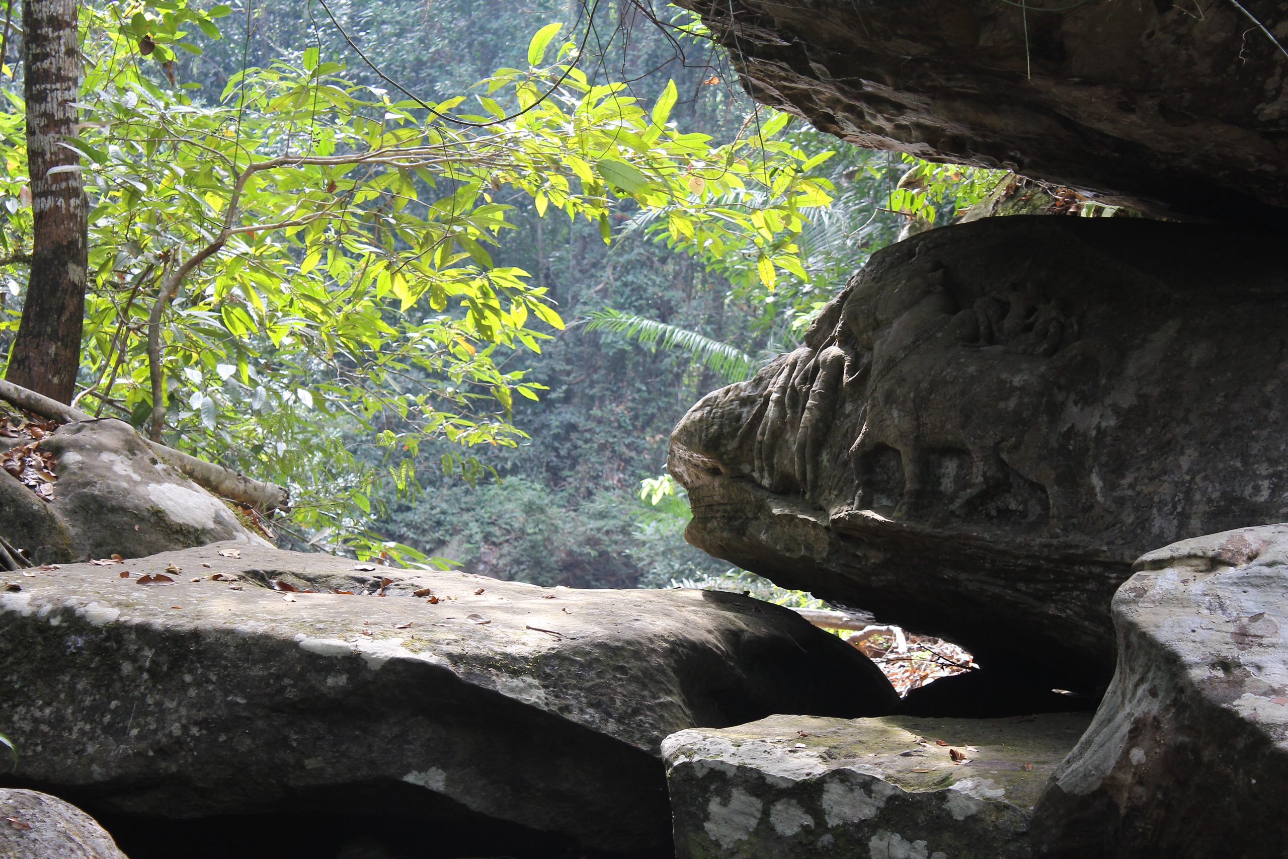 Rocky outcrop with relief of Shiva and Uma on Nandi, overlooking jungle ravine