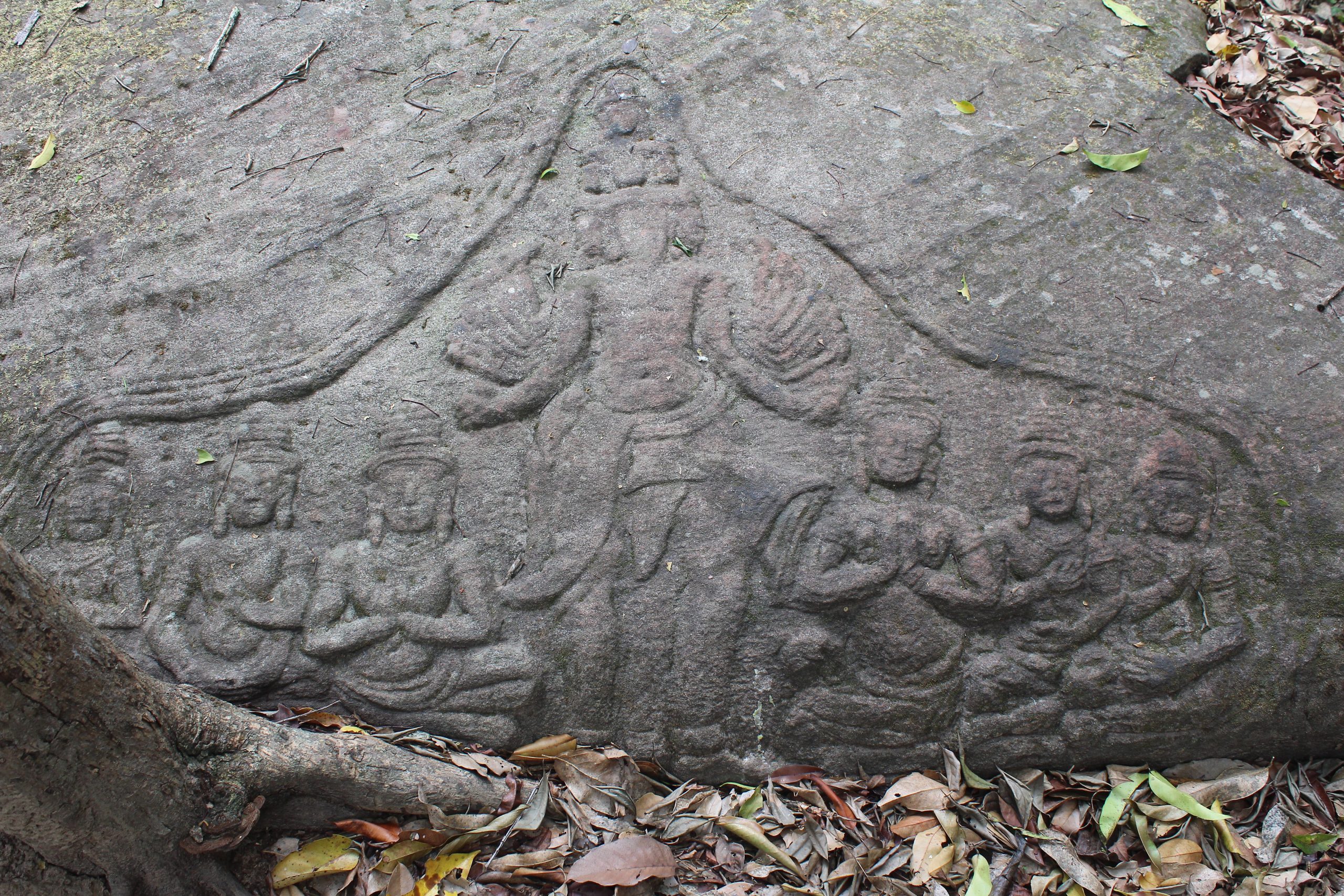 Shallow relief showing multiheaded and multiarmed deity flanked by three devotees on each side