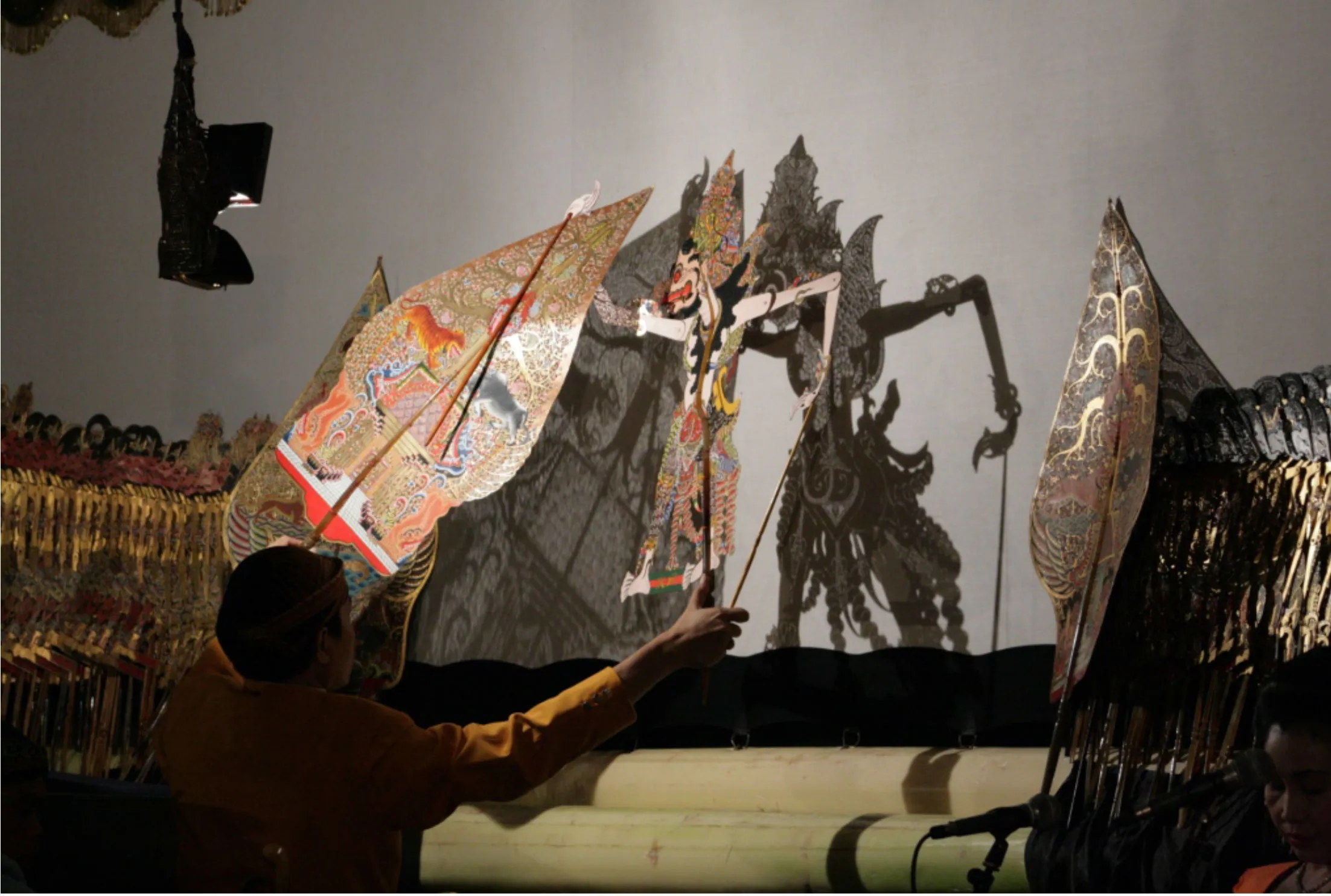 Puppet master working a shadow puppet