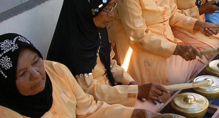 Row of women playing bells