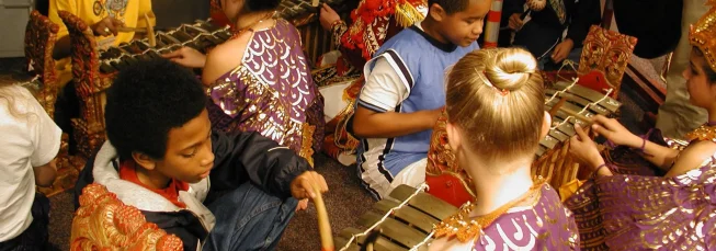 Children playing ugal in a gamelan class