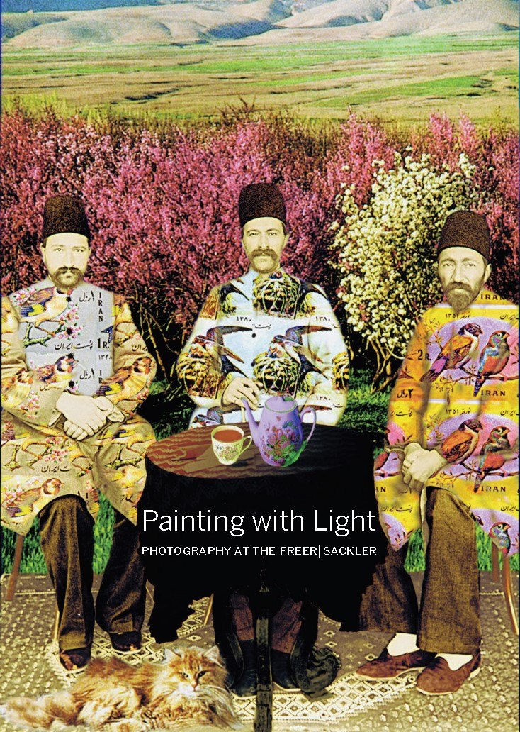 Painting with Light book cover. Three men sit around a circular table with a teapot and teacup. The men gaze out at the viewer, their skin cast in sepia tones. Their clothes are patchworks of bird photographs. Behind the men is a brightly colored natural landscape of pink flowers and rolling hills.