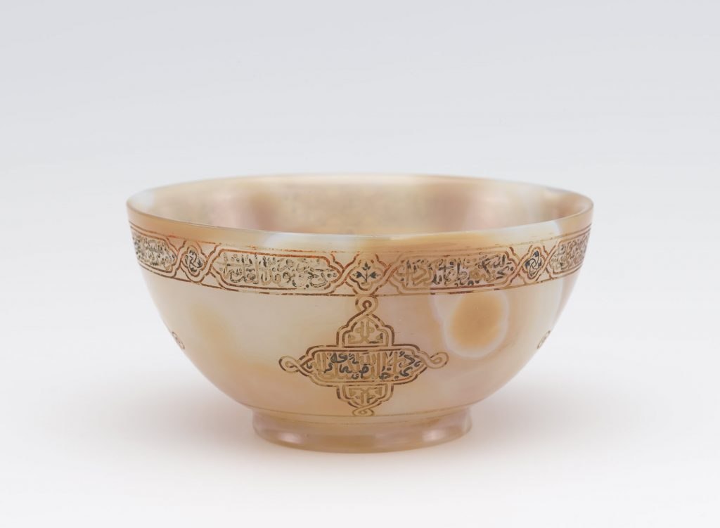 a wine cup made of agate with a decorative bordere