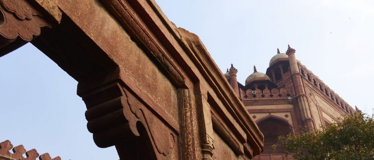 Stone archways against a light blue sky