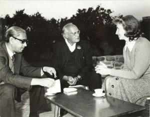 Elizabeth Moynihan meeting with Dr. M.S. Randhawa and another gentleman around a table.